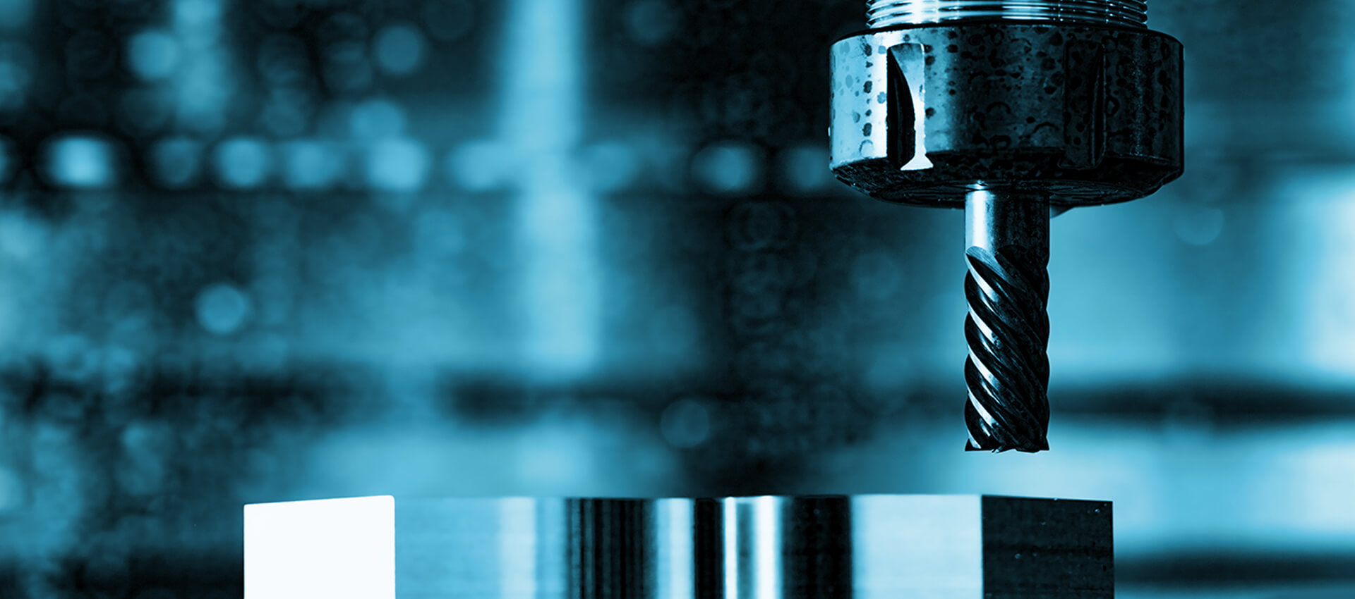 Close-up of a CNC machine cutting into a shiny metal block